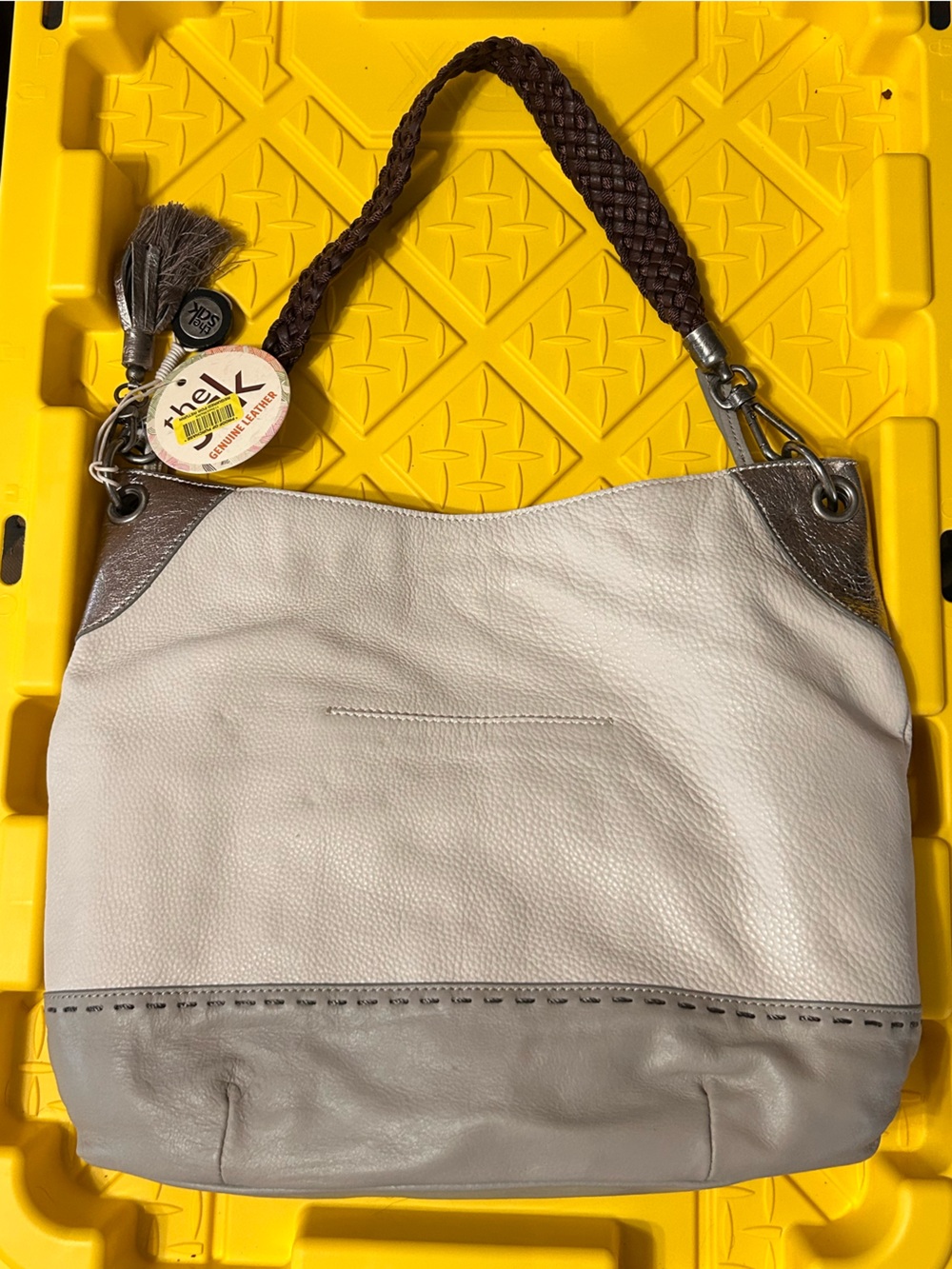The Sak taupe and brown leather tassel wristlet